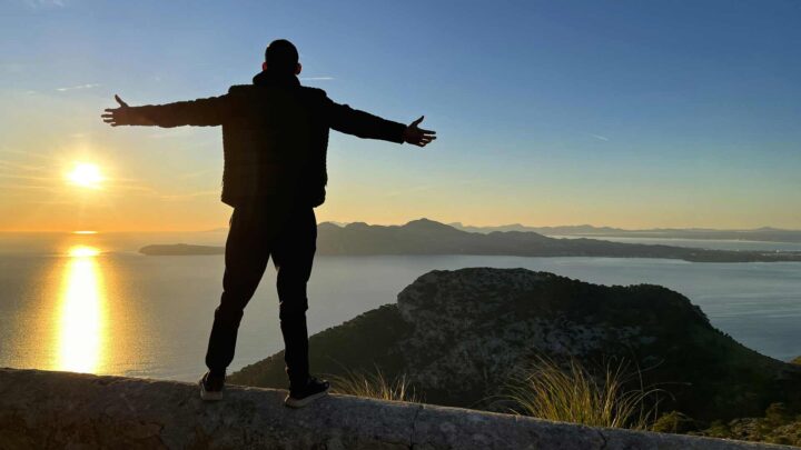 Man standing with arms wide